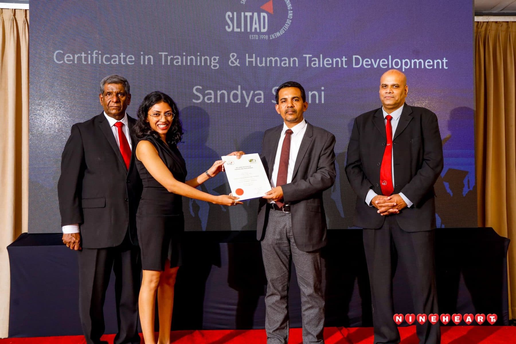 A graduate receives her certificate from the Executive Council